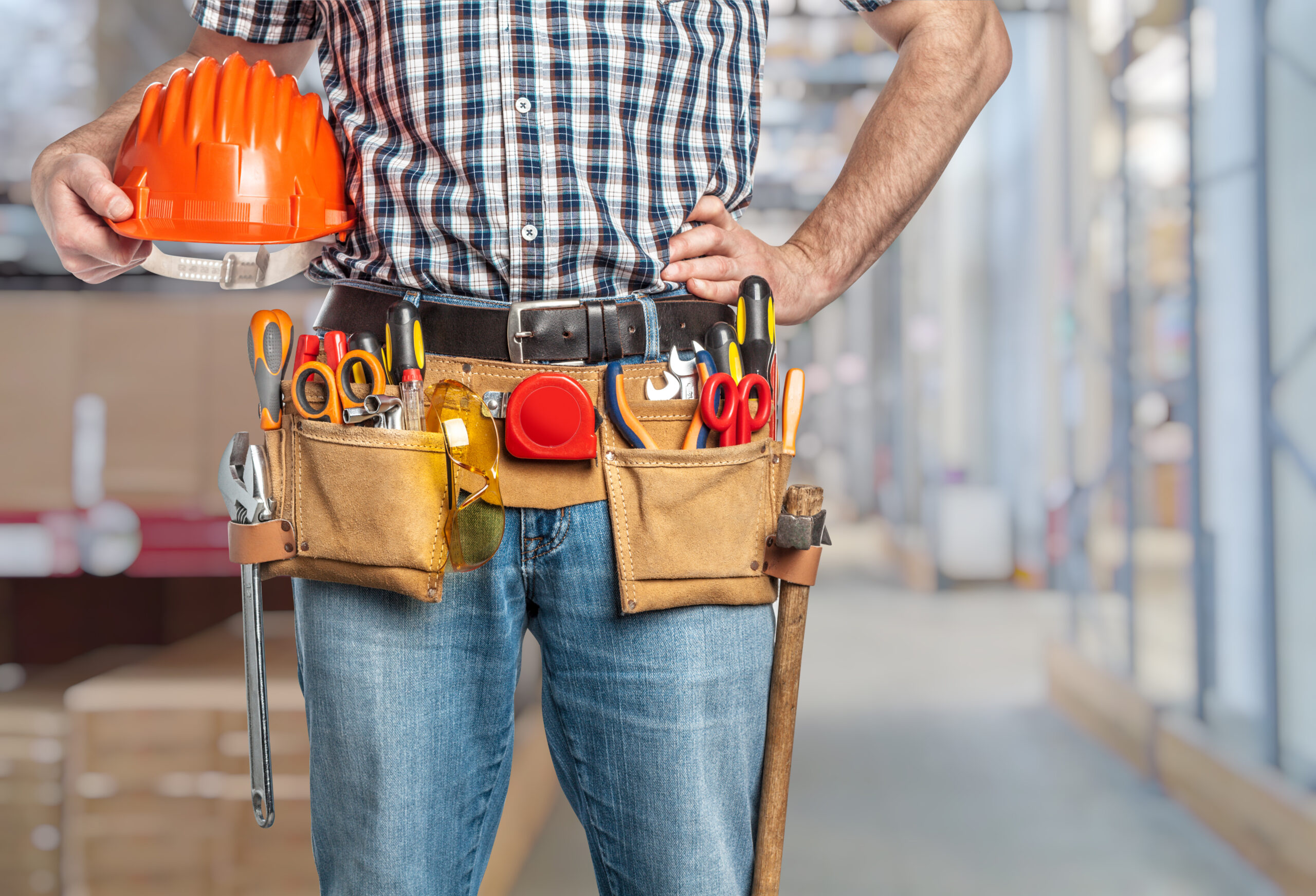 handyman with his helmet in warehouse