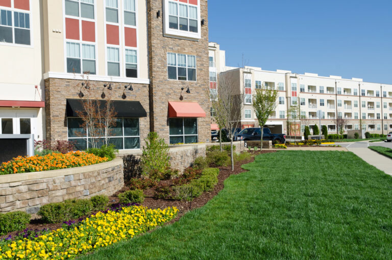 Modern apartment complex building exterior with landscaping