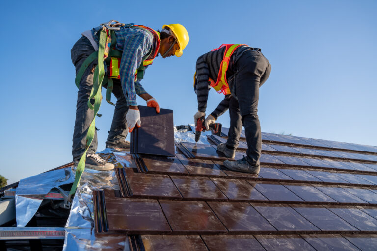 Team work construction worker install new ceramic tile roof in the construction site.